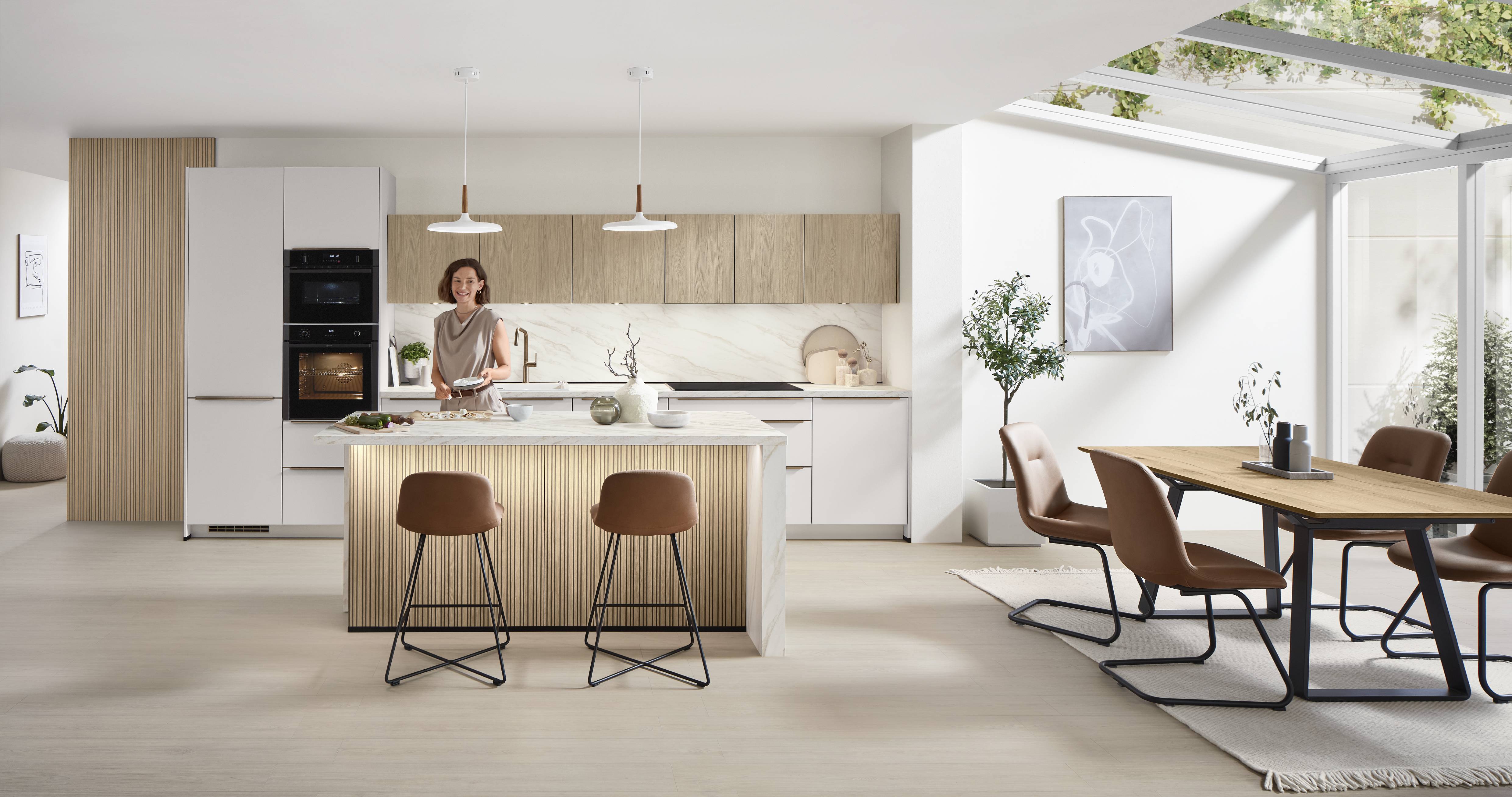 Spacious modern kitchen with sleek appliances, wooden countertops, and stylish shelving, accented by natural light and warm, inviting tones.